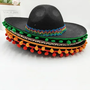 Detailed view of a black Mexican sombrero with colorful pom-poms and patterned trim.