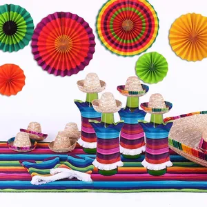 Close-up of mini Mexican sombreros and colorful striped bottle poncho decorations