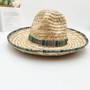 Detail view of handmade Mexican straw hat with vibrant ethnic geometric patterned trim.