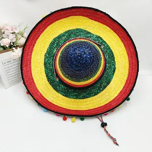 Top view of a vibrant colorful Mexican straw sombrero hat featuring decorative pom-poms