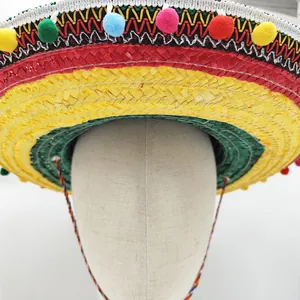 Detailed view of a colorful Mexican straw sombrero with vibrant decorative pompoms