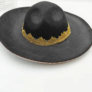 High-quality close-up of gold crown lace trim on a black Mexican holiday party hat