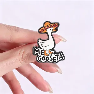 Macro view of a funny white goose enamel pin wearing a Mexican sombrero hat