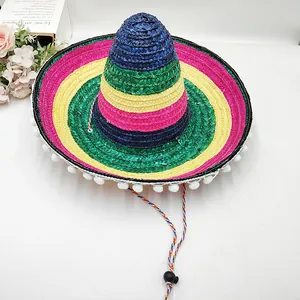 Detailed view of a vibrant rainbow Mexican straw hat with white pom-poms for parties