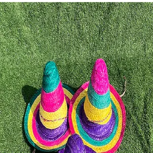 Detailed view of colorful striped Mexican sombreros on green grass for carnival parties.