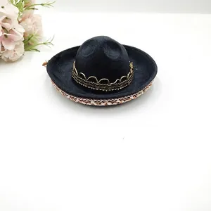 Detailed view of a small black Mexican Sombrero hat with gold trim for festival party decoration