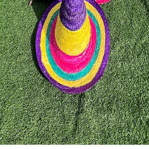 Detailed top view of a colorful Mexican straw sombrero hat on a green grass background