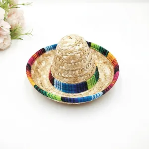 Detail of mini straw sombrero hat with vibrant rainbow striped brim and band