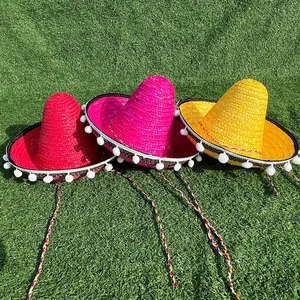 Set of three colorful Mexican straw sombreros with white pom-poms for carnival party