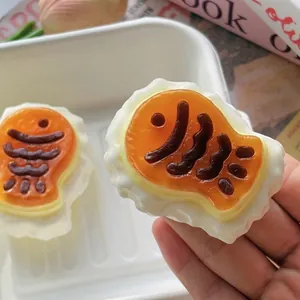 Close-up detail of a cute Taiyaki squishy stress relief toy held in a person's hand