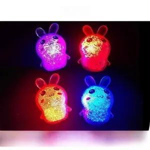 Close-up of four glowing rabbit squishy toys in vibrant colors for stress relief