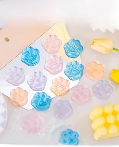 Macro detail of colorful cat paw jelly squishy toys on a mirror surface with soft lighting.