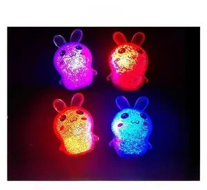 Detail of four glowing bunny-shaped squeeze toys with colorful internal LED lights.