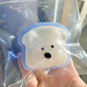 Detail shot of a cute white Westie dog toast squishy toy for stress relief in plastic bag