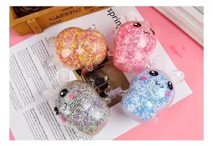 Four colorful light-up bunny squishy stress relief toys displayed on a pink background