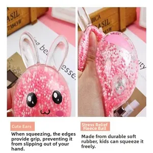 Detail view of a pink rabbit squeeze toy showing soft TPR material and foam bead filler.