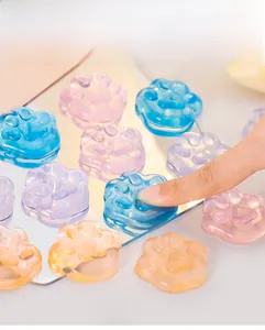 Close-up of colorful translucent cat paw jelly stress relief toys on a bright surface