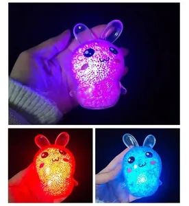 Close-up of cute glowing rabbit squishy toys in pink red and blue colors for stress relief