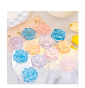 Detailed view of colorful cat paw shaped jelly stress relief toys on a decorative table