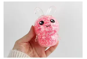 Close-up of a cute pink rabbit stress relief squishy toy filled with colorful beads