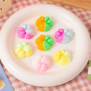 Colorful cat paw squishy toys for stress relief, seven pieces on a white plate