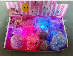 Macro view of LED light-up squishy rabbit toys in a display box for stress relief.