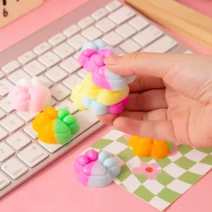 Cute colorful cat paw squishy decompression toys for stress relief on pink office desk