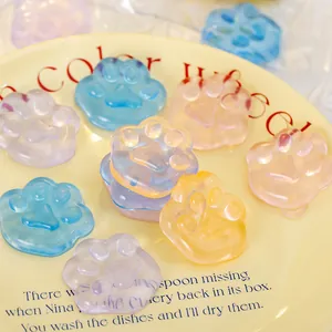 Colorful translucent cat paw jelly squishy toys on a yellow plate for kids stress relief