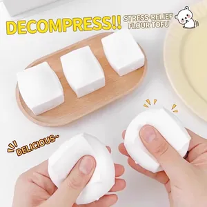 Close-up showing the soft slow-rebound texture of the white tofu squeeze stress toy