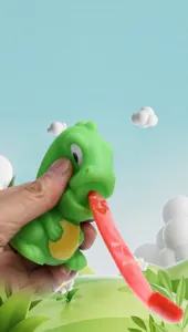 Close-up detail of a green dinosaur squeeze toy with an extending long red tongue