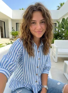 Casual women's blue and white striped button-down shirt with a stylish peplum hem