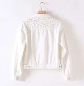 Detailed back view of a white denim jacket featuring elegant pearl embellishments