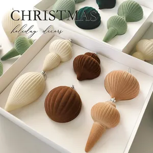 Set of elegant flocked velvet Christmas ornaments in assorted shapes and warm neutral tones