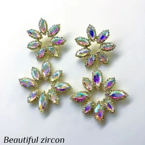 Macro view of exaggerated flower-shaped earrings with iridescent AB crystals