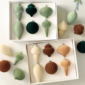 Set of elegant flocked Christmas ornaments in various shapes and earthy muted tones