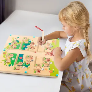 Young girl playing with a wooden magnetic marble maze board for logic training.