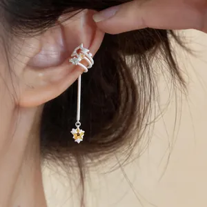 Detailed close-up of a multi-layer star ear cuff with zircon and a long tassel
