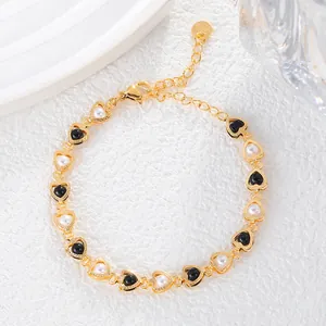 Detailed view of elegant gold heart bracelet featuring alternating black and white beads