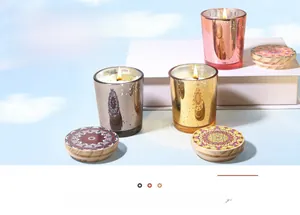 Close-up of starry sky scented candles in gold, silver, and pink glass jars with mandala lids.