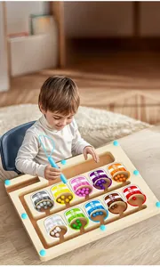 Toddler playing with magnetic ball maze toy for color sorting and logic skill development