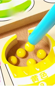 Detail view of a magnetic pen attracting yellow beads in a logical wooden puzzle toy