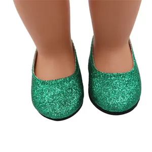 Detail view of sparkling green glitter shoes for 18-inch dolls on white background