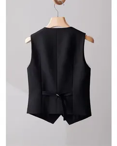 Back view of a black tailored women's suit vest with adjustable waist strap detail