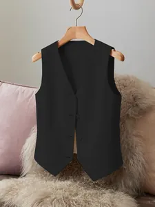 Close-up detail of women's black short suit vest featuring a V-neck and button closure