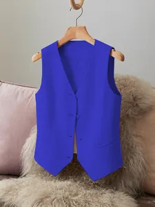 Close-up detail of a vibrant royal blue women's tailored suit vest waistcoat on a hanger