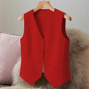 Close-up detail of a bright red women's tailored suit vest featuring classic buttons.