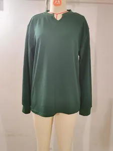 Close-up of a dark green waffle-knit long-sleeve V-neck shirt displayed on a mannequin
