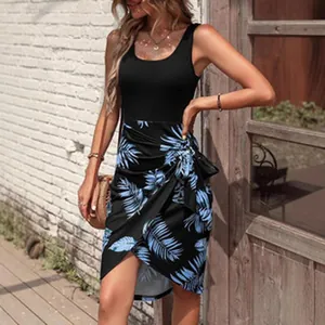 Detail view of a women's summer dress featuring a black tank top and blue leaf print skirt.