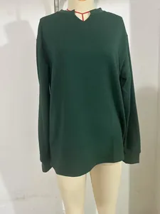 Detailed view of the dark green waffle-knit texture on a casual V-neck long sleeve shirt