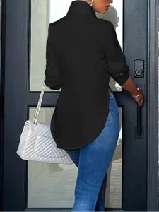 Back view detail of women's black long sleeve shirt with an irregular curved hemline